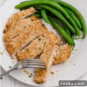 Crispy Air-Fried Chicken Breast 12 Overhead sliced air fried chicken breast with side of green beans on a white plate.