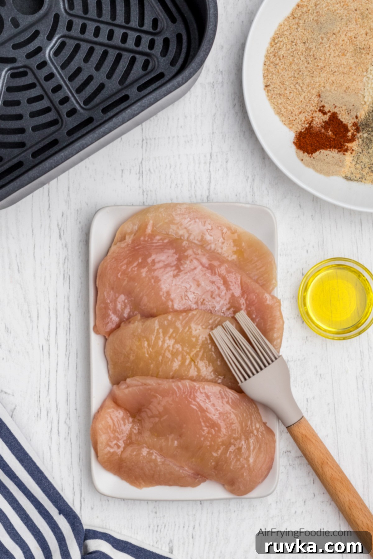 Crispy Air-Fried Chicken Breast 4 Chicken breast being brushed with olive oil.