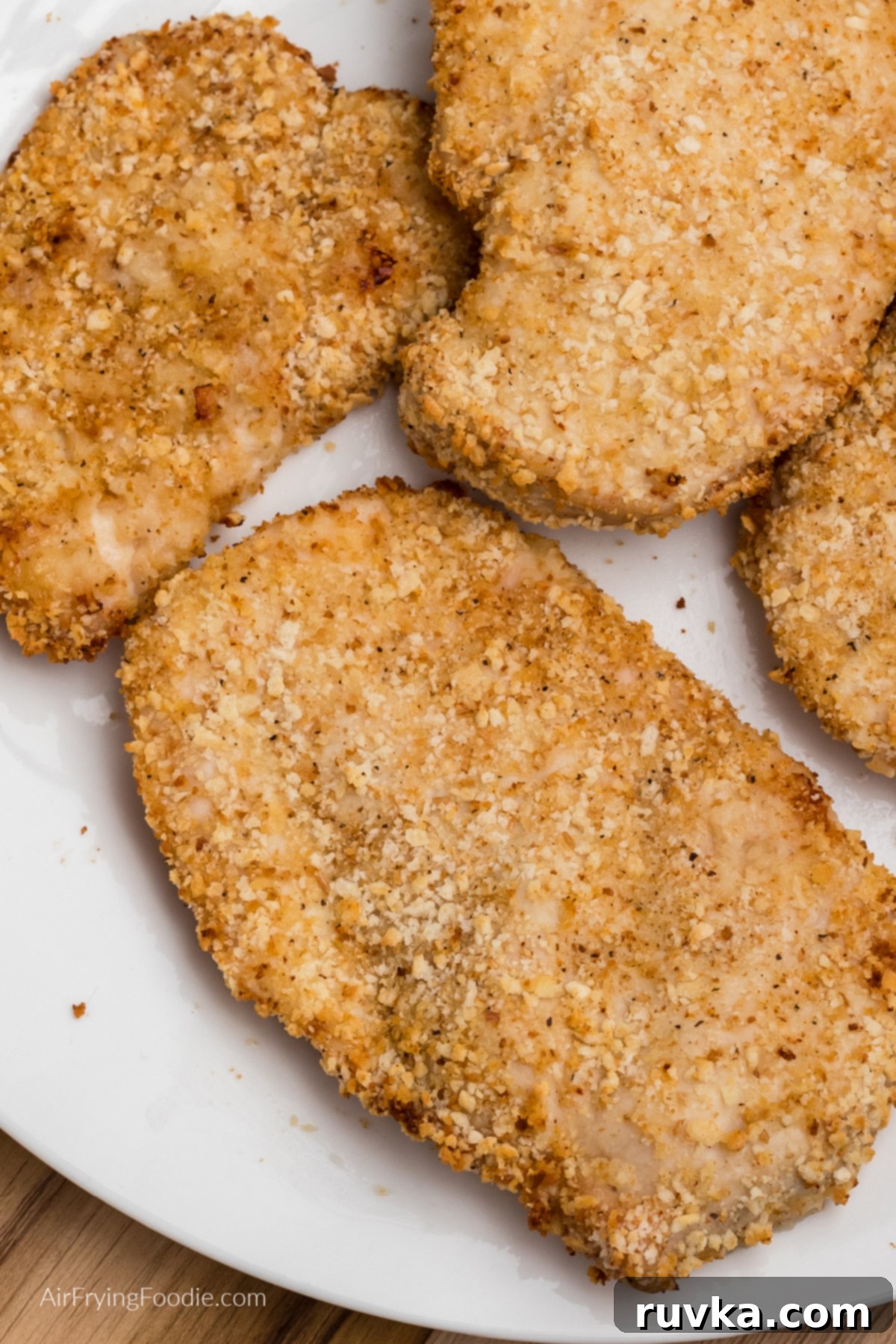 Crispy Air-Fried Chicken Breast 10 close up of air fryer fried chicken breast on a white plate ready to serve.