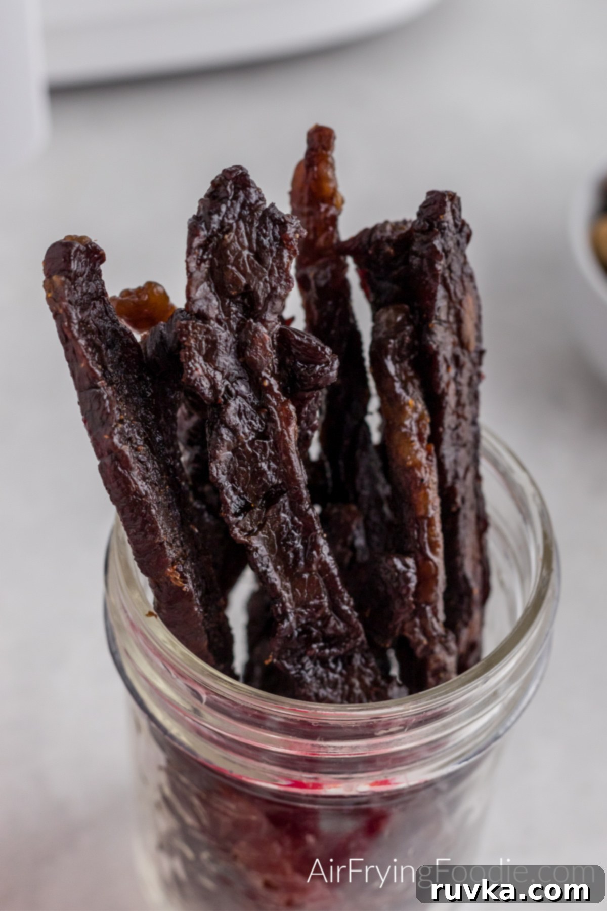 Homemade Air Fryer Jerky 9 Close up shot of beef jerky made in the air fryer in a jar, ready to serve.