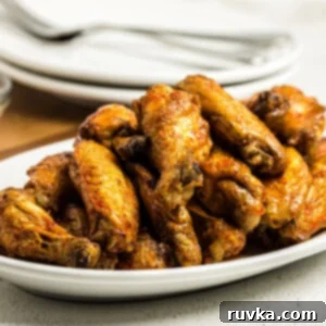 Air Frying Made Simple 21 Air Fried Buffalo Chicken Wings on a white serving dish.