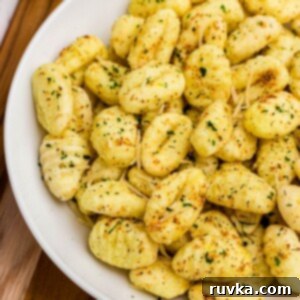 Crispy Air-Fried Gnocchi 9 Golden crispy gnocchi in a white bowl, seasoned and ready to eat.