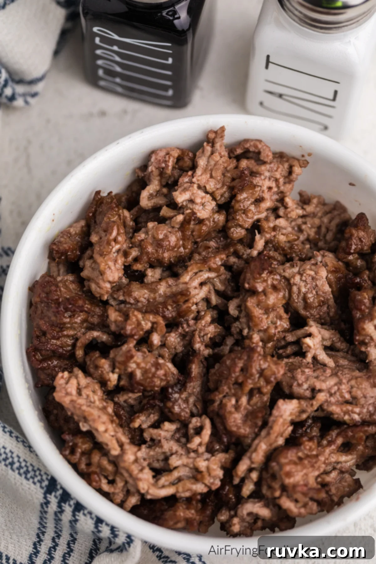 Easy Air Fryer Ground Beef 8 CLose up photo of air fried ground beef in a white bowl.