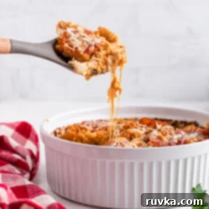 Air Fryer Pizza Pasta Bake 12 Air fryer Pizza pasta casserole being scooped from the casserole dish.