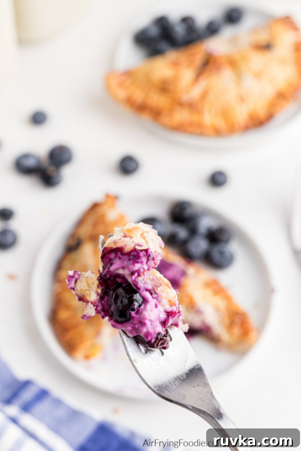 Crispy Air Fried Blueberry Pockets 15 Bite of blueberry hand pie on the end of a fork.