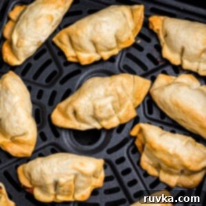 Crispy Air Fryer Frozen Potstickers 7 Golden crispy potstickers in the air fryer basket after being cooked.