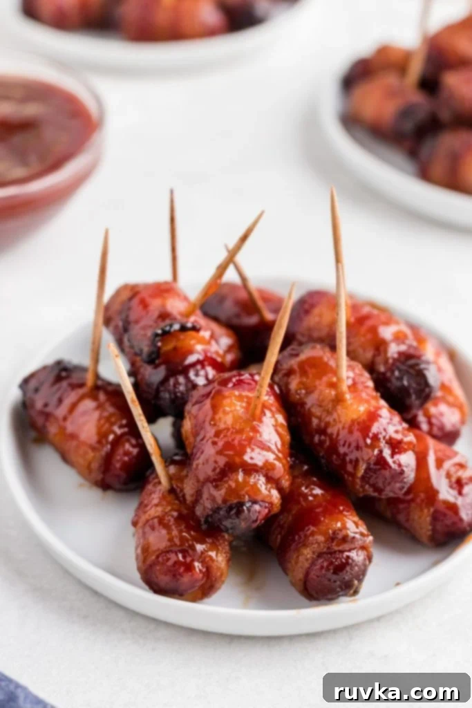 Crispy Air-Fried Bacon-Wrapped Smokies 2 BBQ glazed bacon wrapped smokies on a small white plate