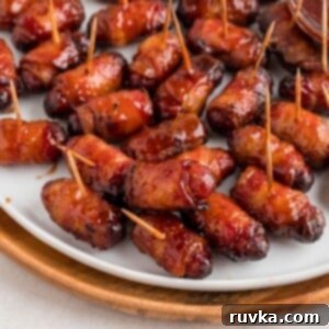 Crispy Air-Fried Bacon-Wrapped Smokies 10 BBQ coated bacon wrapped smokies on a white plate