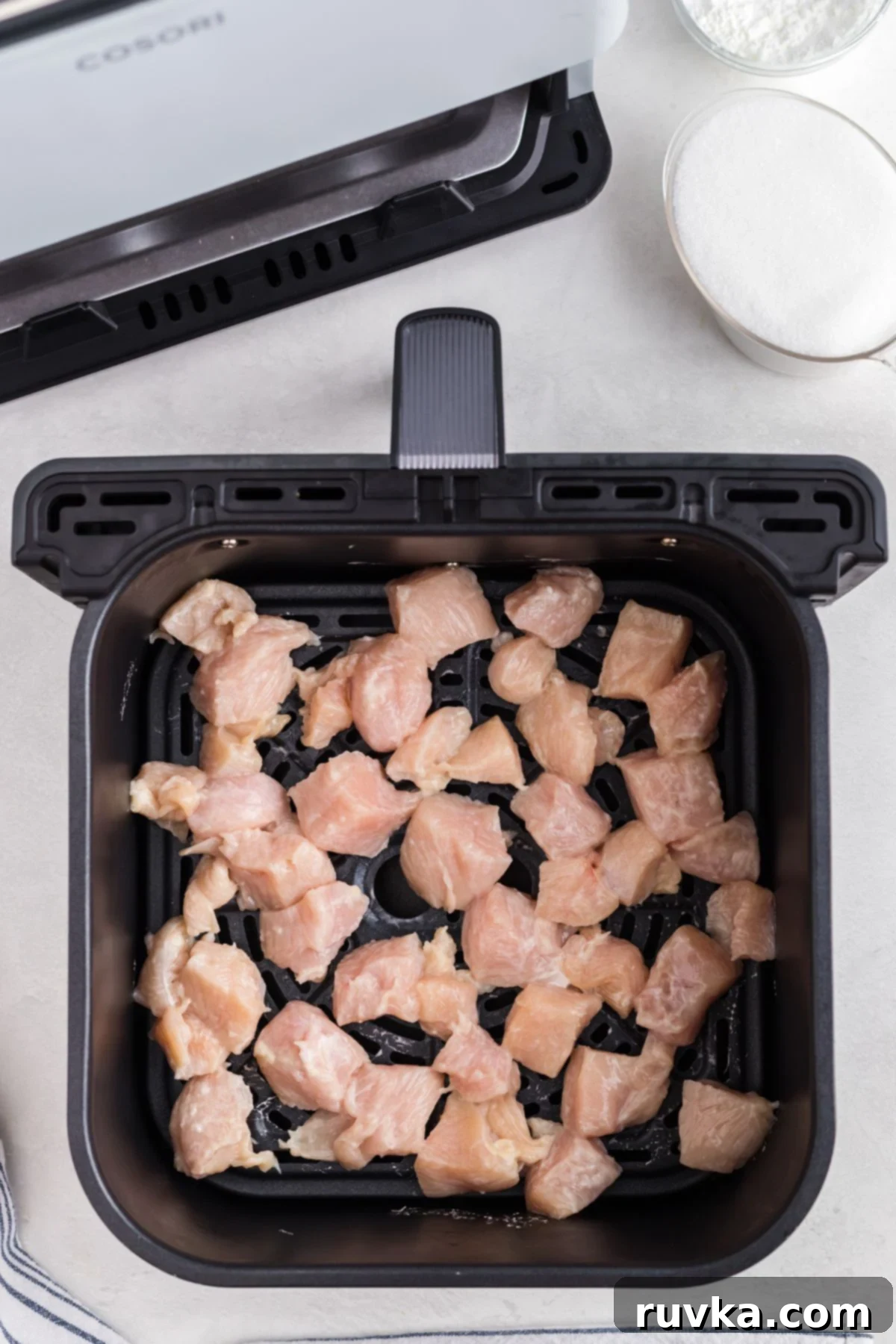 Golden Crispy Air Fryer Orange Chicken 5 Uncooked chicken in the air fryer basket