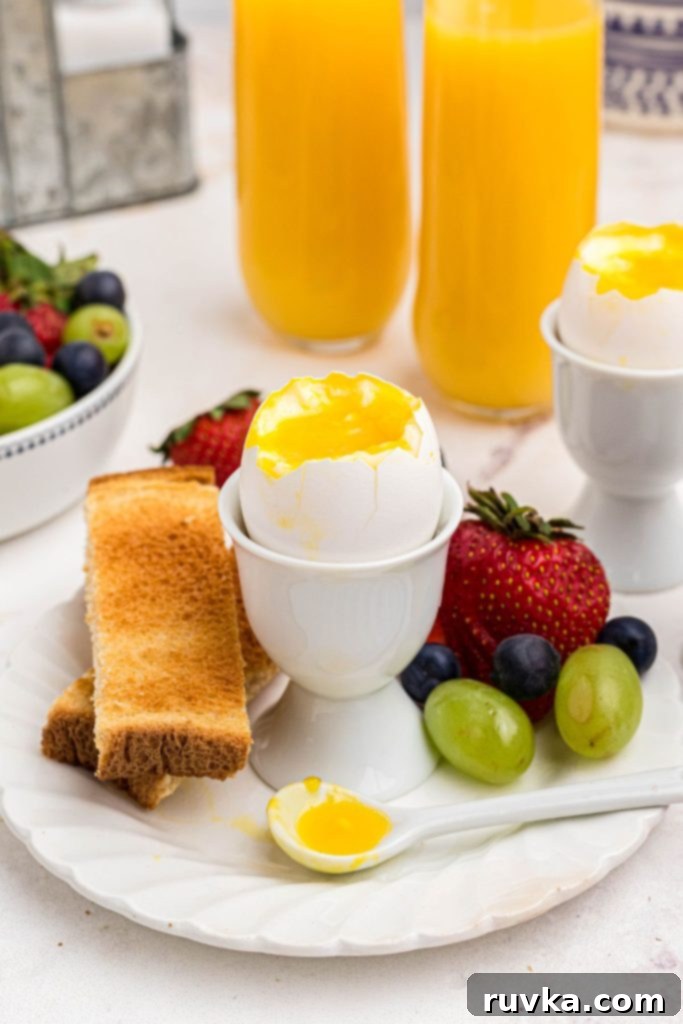 Air Fryer Jammy Eggs 7 Slightly runny yolk inside of an egg shell in an egg holder with fruit and toast.