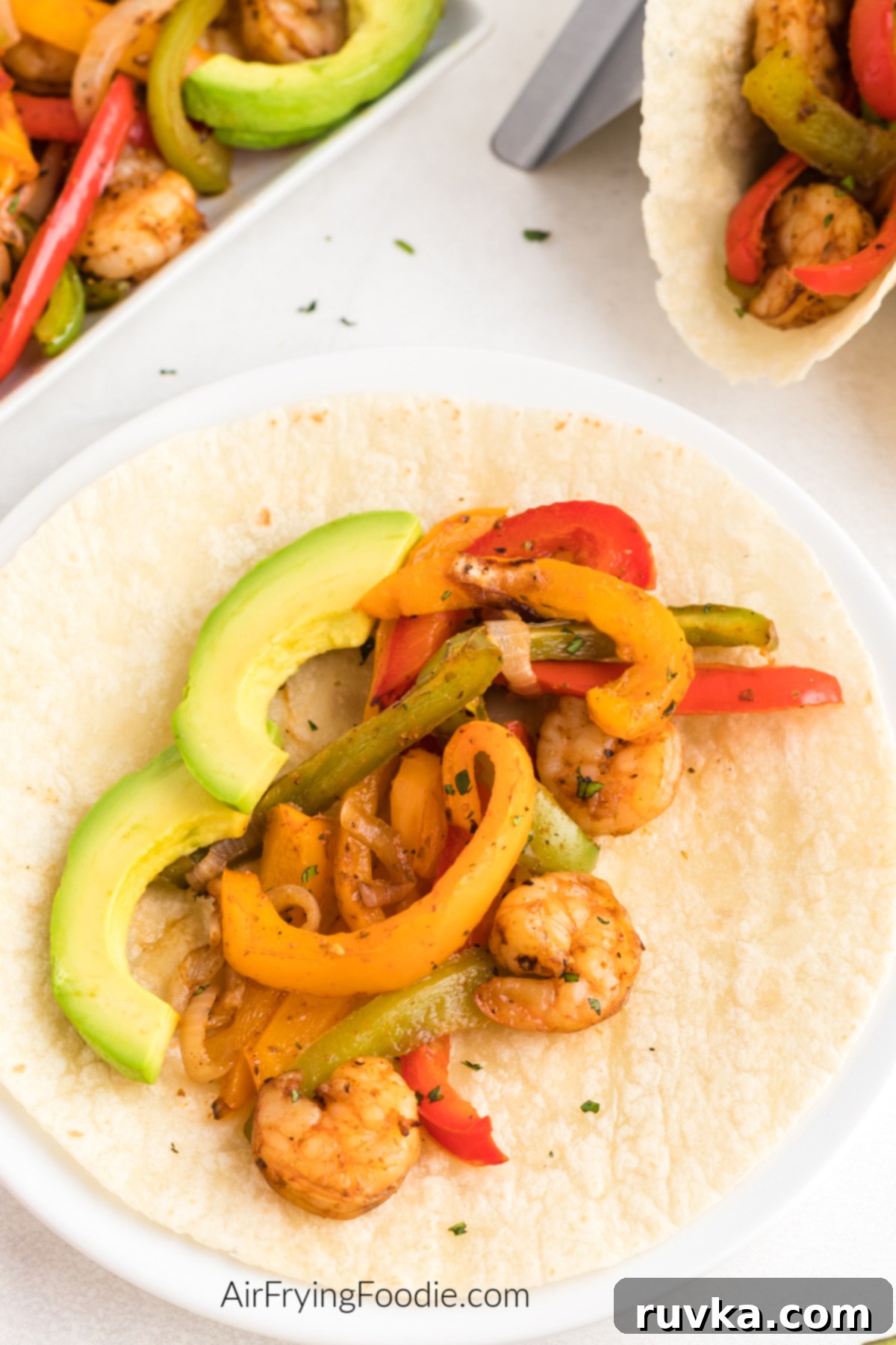 Effortless Air Fryer Shrimp Fajitas 7 Air fried shrimp fajitas on a flour tortilla, ready to serve.