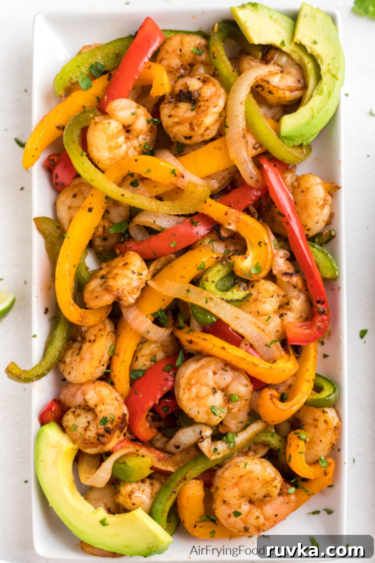 Effortless Air Fryer Shrimp Fajitas 8 Tray full of shrimp fajitas made with shrimp, onion, and bell peppers in the air fryer and ready to serve.