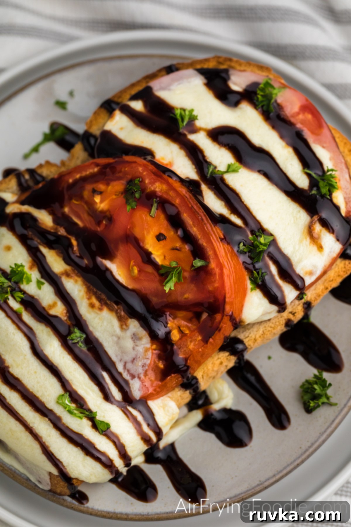 Air Fryer Caprese Melts 9 Balsamic glazed Caprese grilled cheese on a plate topped with fresh parsley.