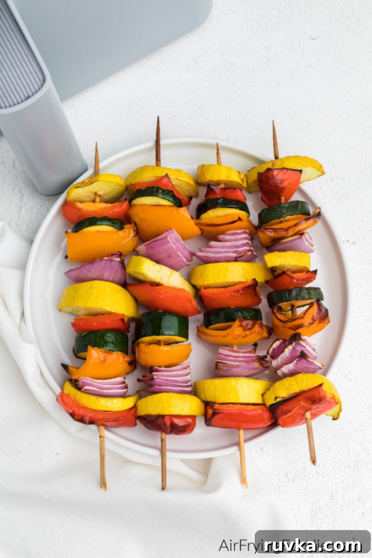 Crispy Air Fryer Vegetable Skewers 2 Beautifully air-fried vegetable kabobs served on a pristine white plate, showcasing vibrant colors and perfect char.