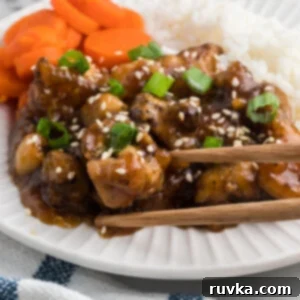 Sticky Sweet Air Fryer Teriyaki Chicken 12 Air fryer teriyaki chicken on a plate with a side of rice and sliced carrots.