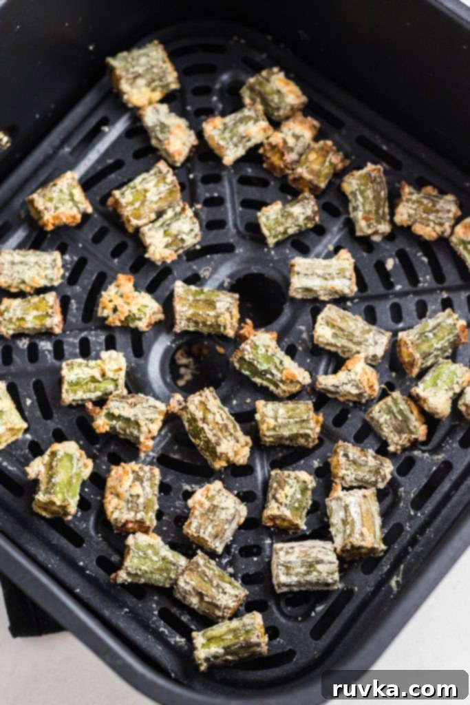 Crispy Air Fryer Okra 7 Golden fried seasoned okra in the air fryer basket.