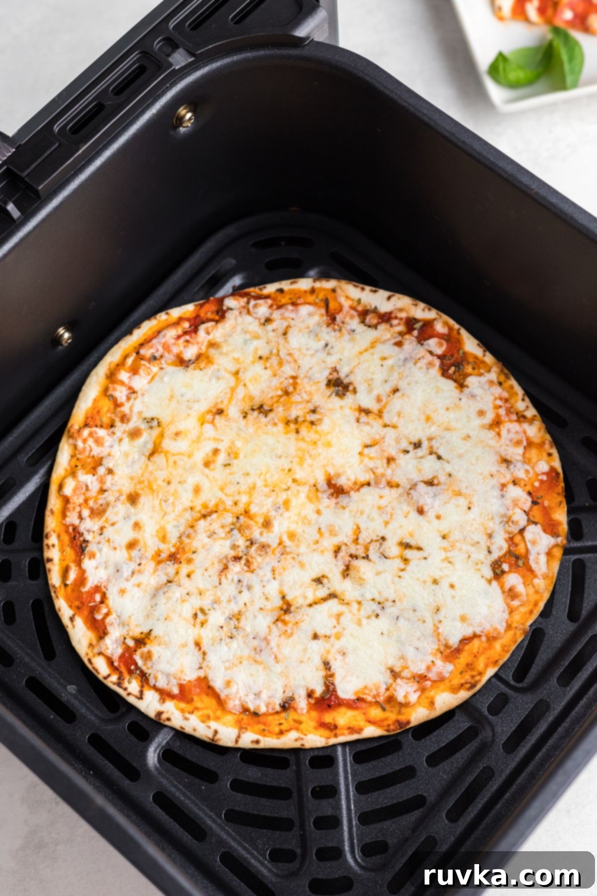 Crispy Air Fryer Tortilla Pizzas 6 Golden tortilla topped with melted cheese and seasonings.