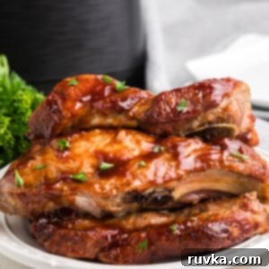 Air Fryer Favorites for Memorial Day 3 Close up of country style ribs made in the air fryer with the air fryer in the background.