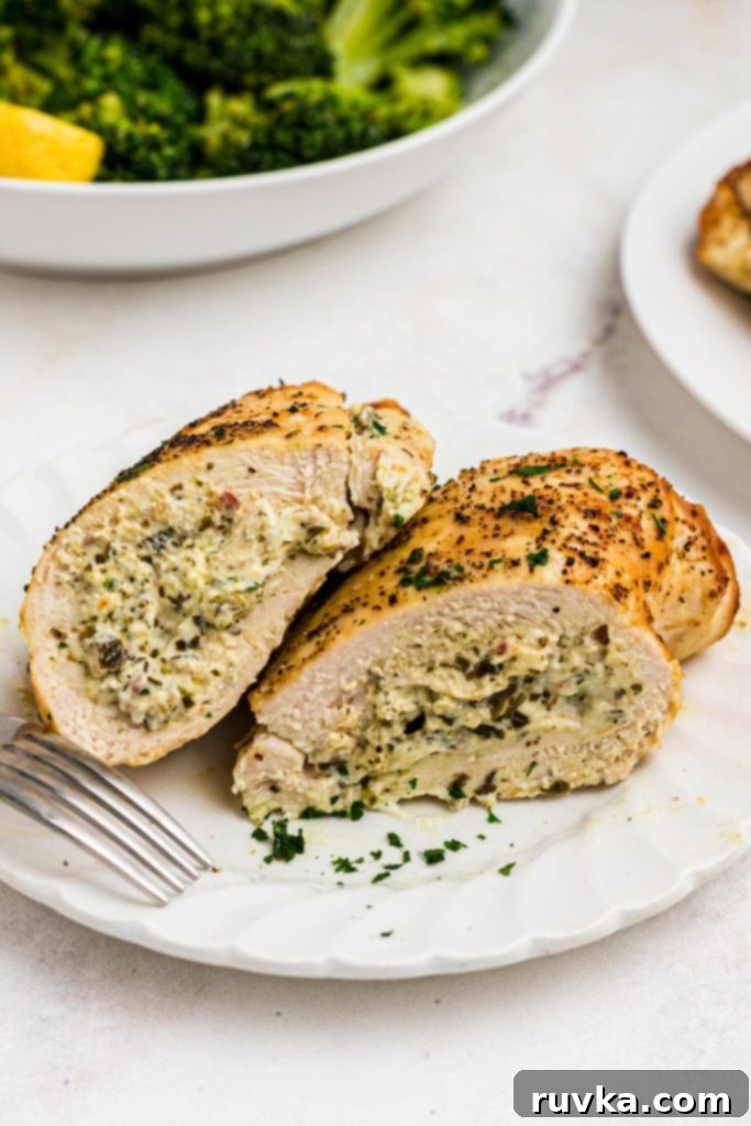 Crispy Air Fryer Stuffed Chicken 2 Golden cooked chicken stuffed with basil pesto, cream cheese, and seasonings.