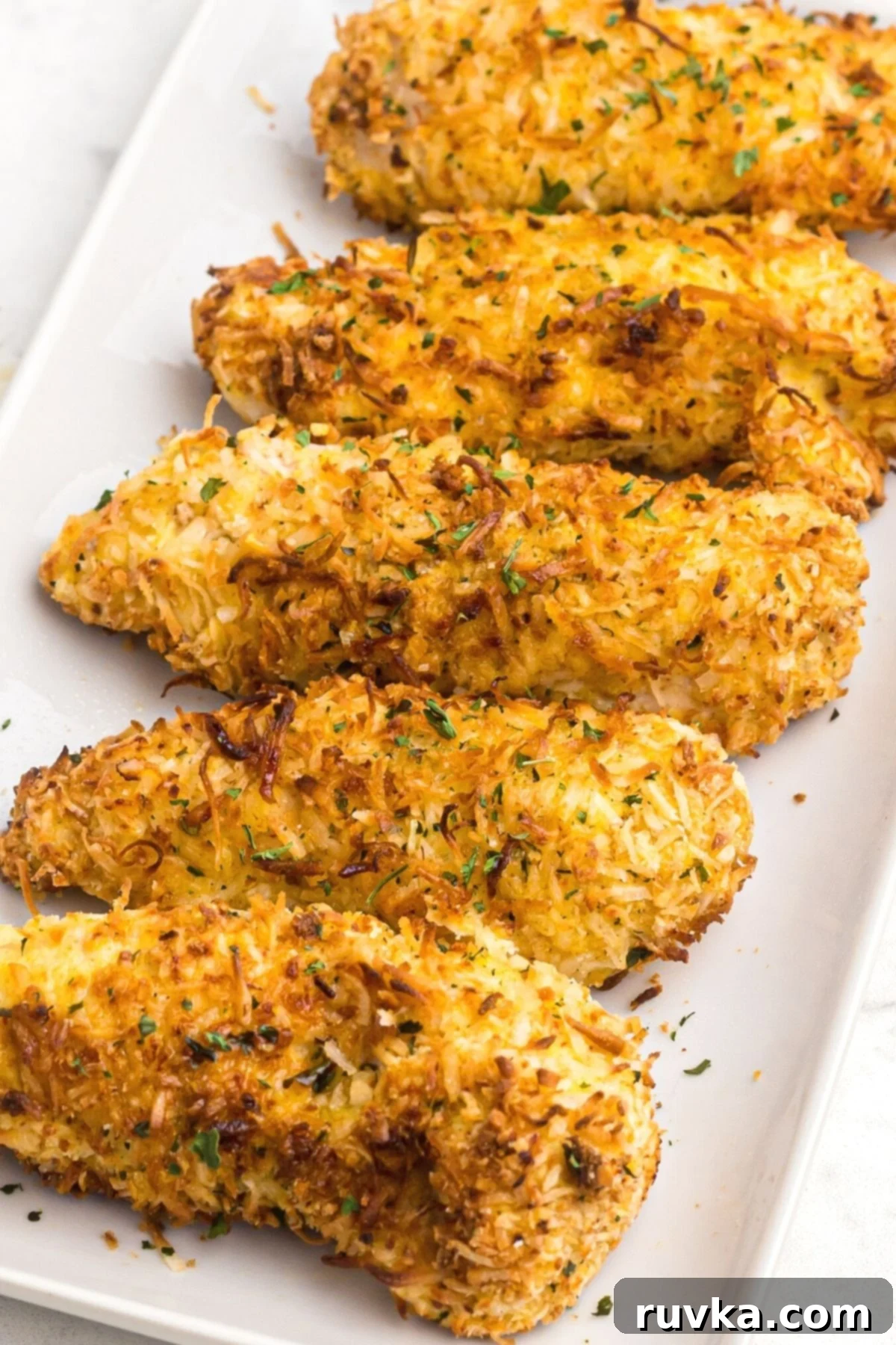Delicious Air Fryer Chicken Recipes Made Easy 22 Air fried coconut chicken, beautifully golden brown and crispy, served on a white platter for an easy dinner.