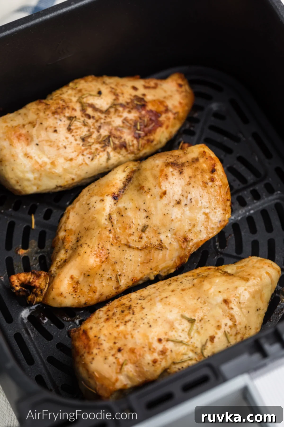 Delicious Air Fryer Chicken Recipes Made Easy 30 Air fryer grilled chicken breast, fully cooked and seasoned, resting in the air fryer basket.