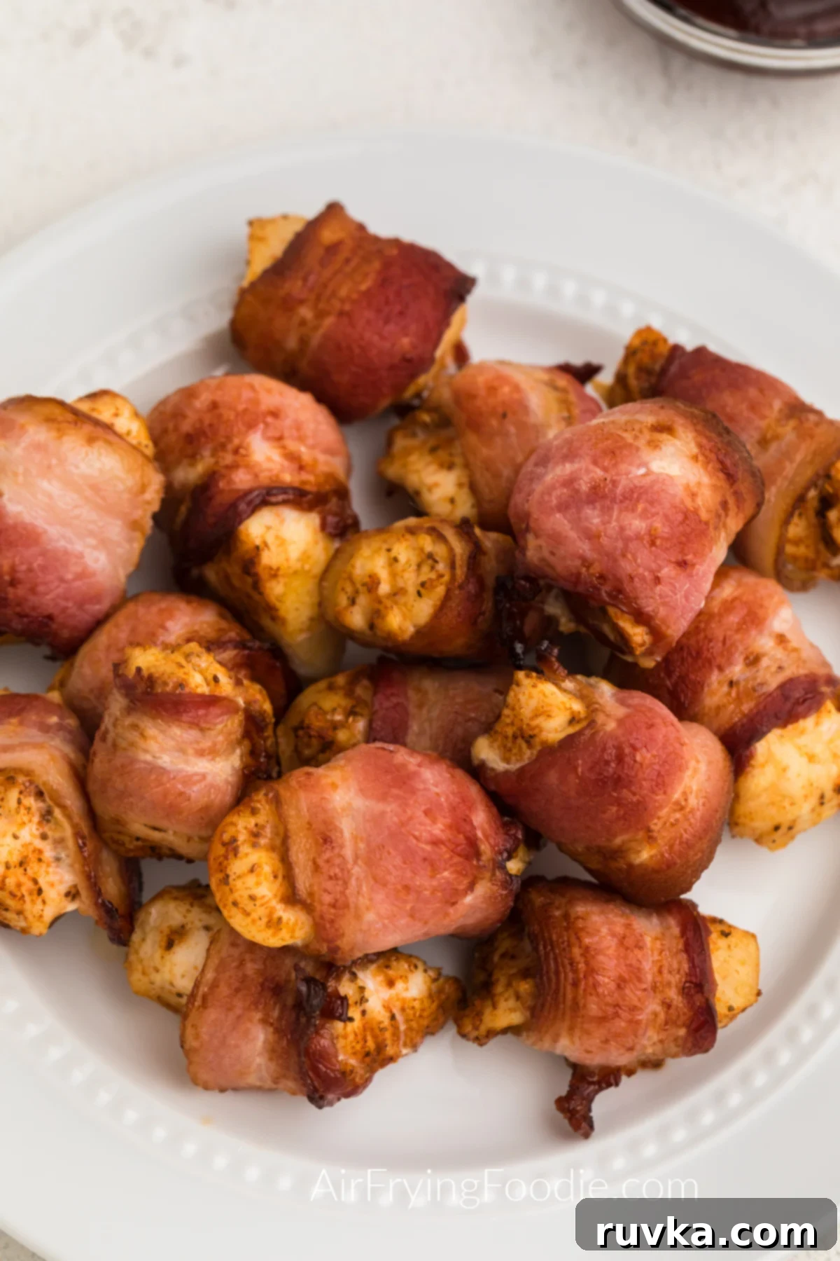 Delicious Air Fryer Chicken Recipes Made Easy 31 A plate of air fried bacon-wrapped chicken bites, showcasing their crispy texture, ready to be enjoyed as an appetizer.