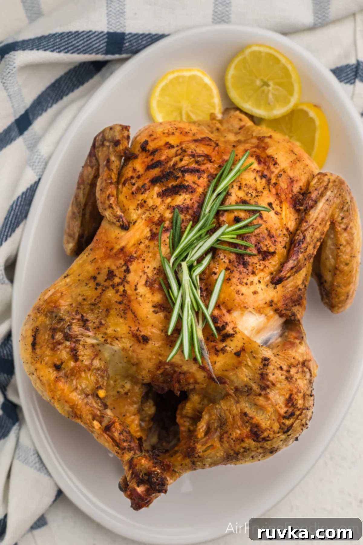Delicious Air Fryer Chicken Recipes Made Easy 32 Air fried whole chicken, golden brown and perfectly roasted, served on a platter ready to be carved.