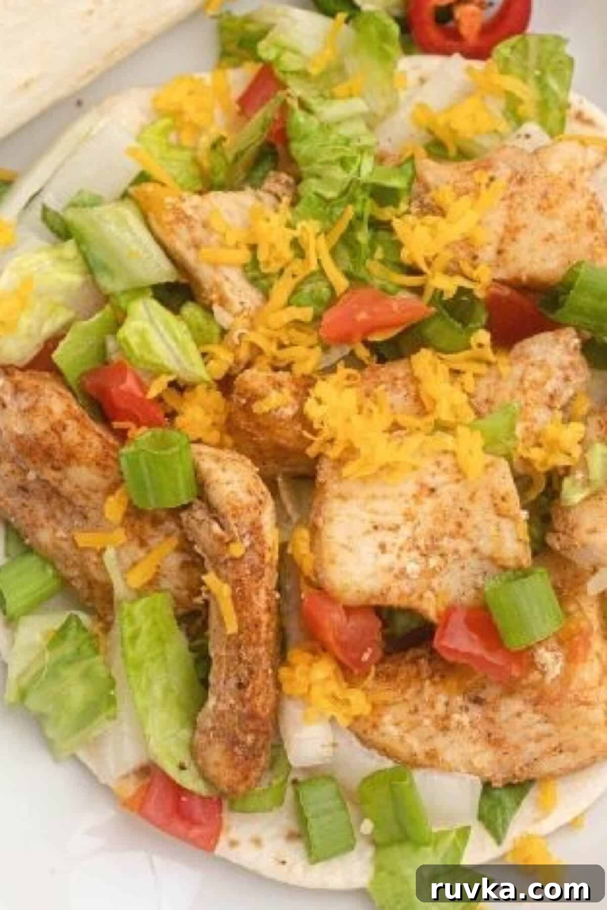 Delicious Air Fryer Chicken Recipes Made Easy 37 Air fryer chicken street tacos, filled with flavorful chicken and fresh toppings, served on a white plate.
