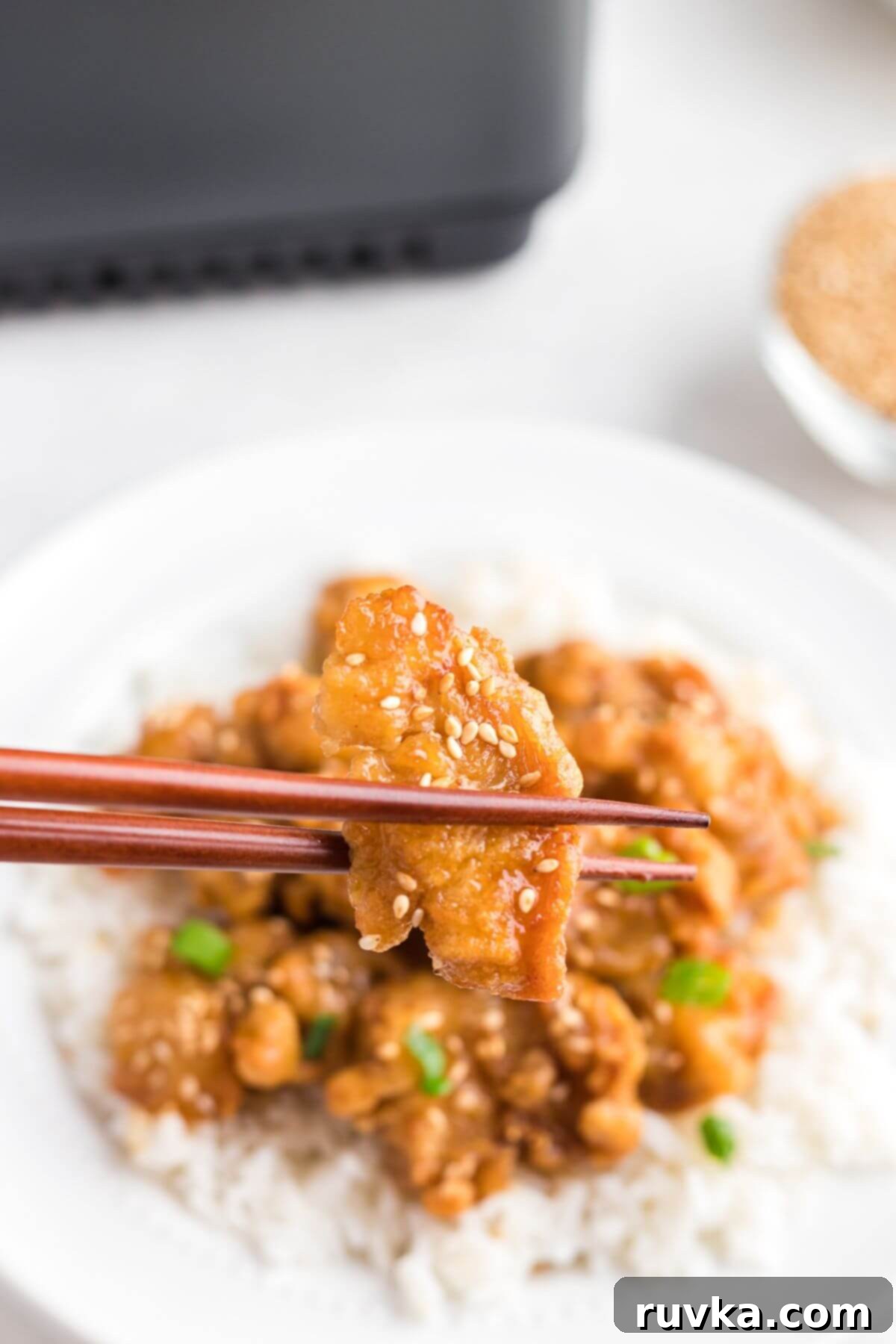 Delicious Air Fryer Chicken Recipes Made Easy 52 Air fryer Trader Joe's orange chicken, crispy and saucy, served on a plate with fluffy white rice.