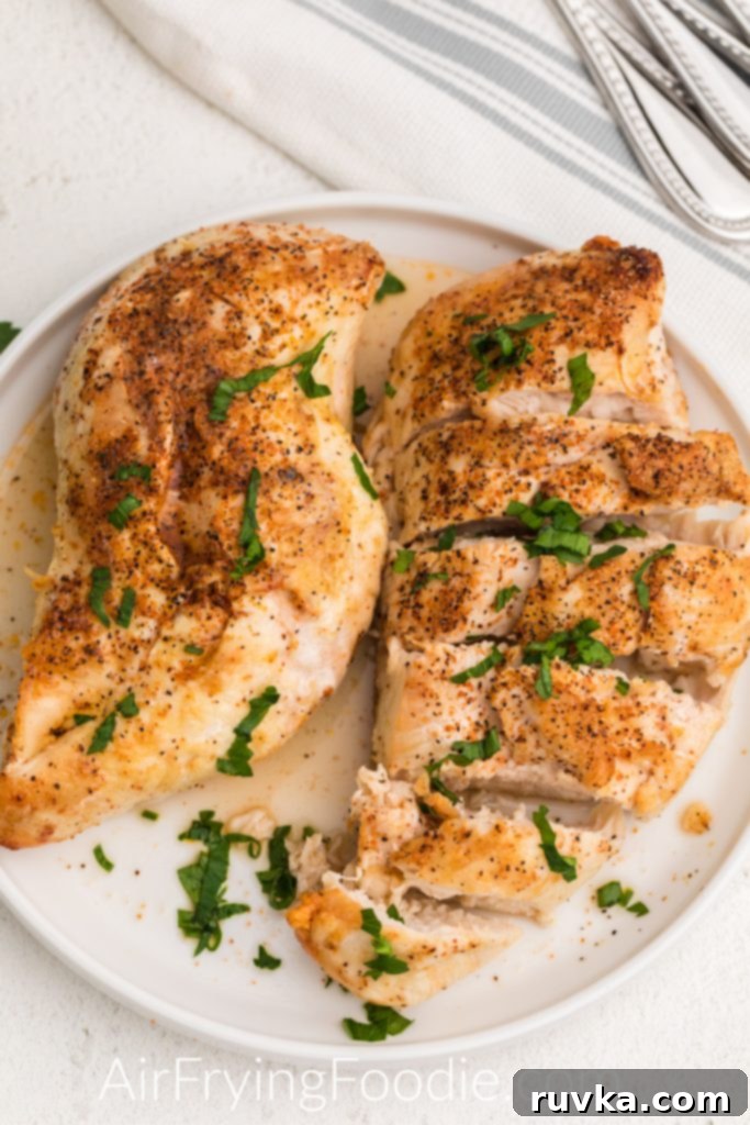 Delicious Air Fryer Chicken Recipes Made Easy 9 Perfectly air fried frozen chicken breast, cooked and served on a pristine white plate.