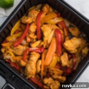 Easy Air Fryer Dinners 5 chicken fajitas in air fryer basket ready to serve.