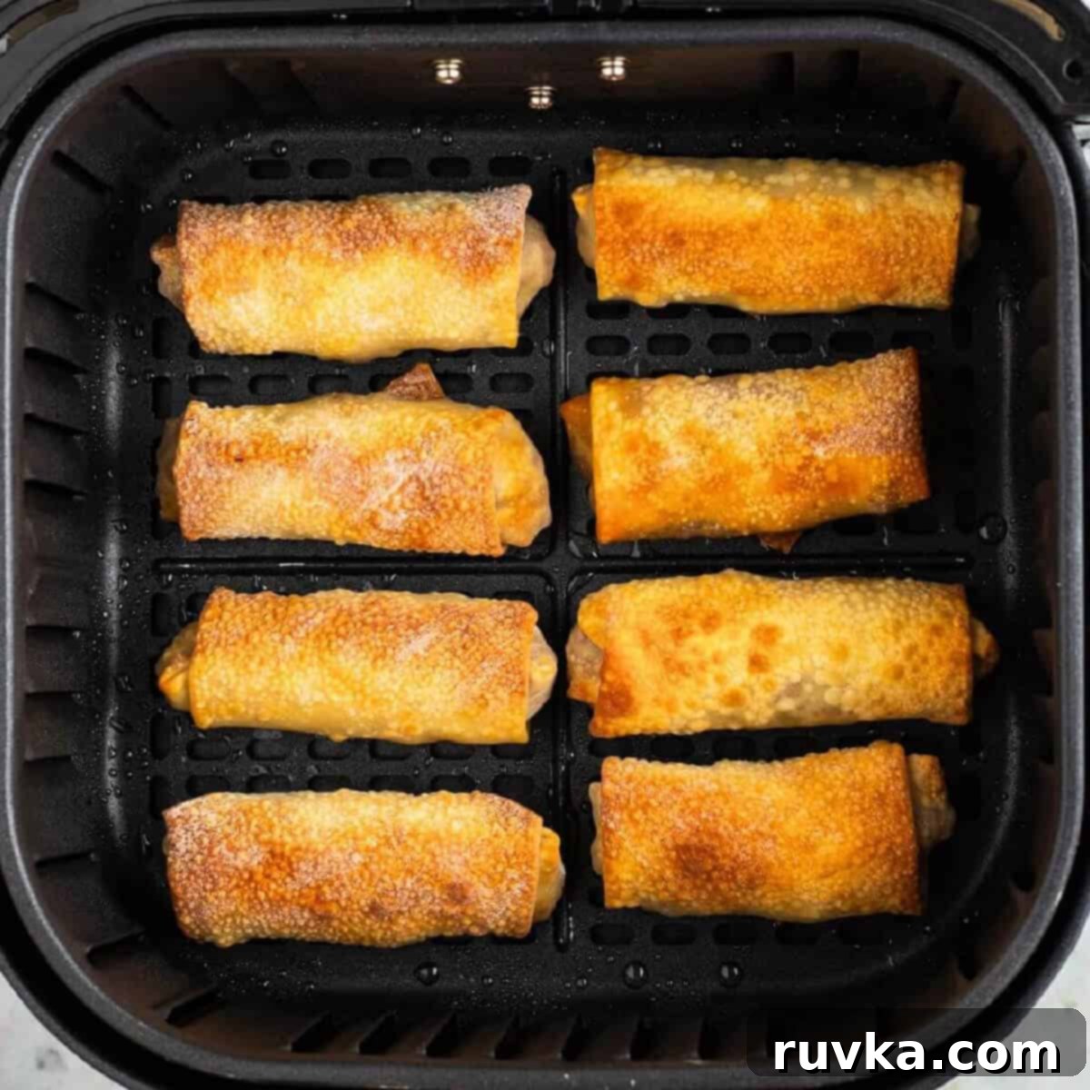 Mastering Air Fryer Leftovers for Crispy Results 11 Egg rolls in the air fryer basket, fully cooked, and ready to serve.
