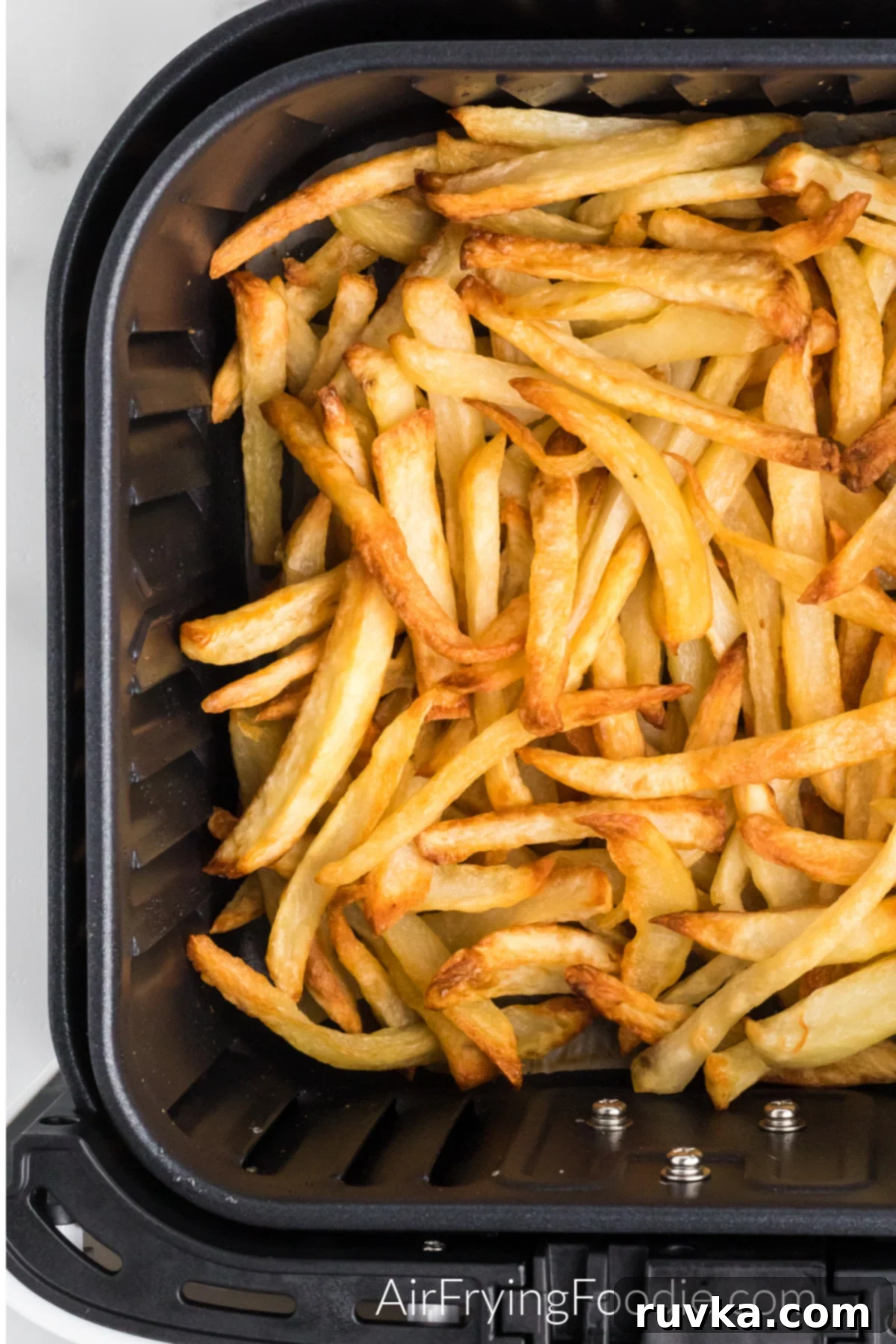Mastering Air Fryer Leftovers for Crispy Results 6 reheating fries in the basket of the air fryer.