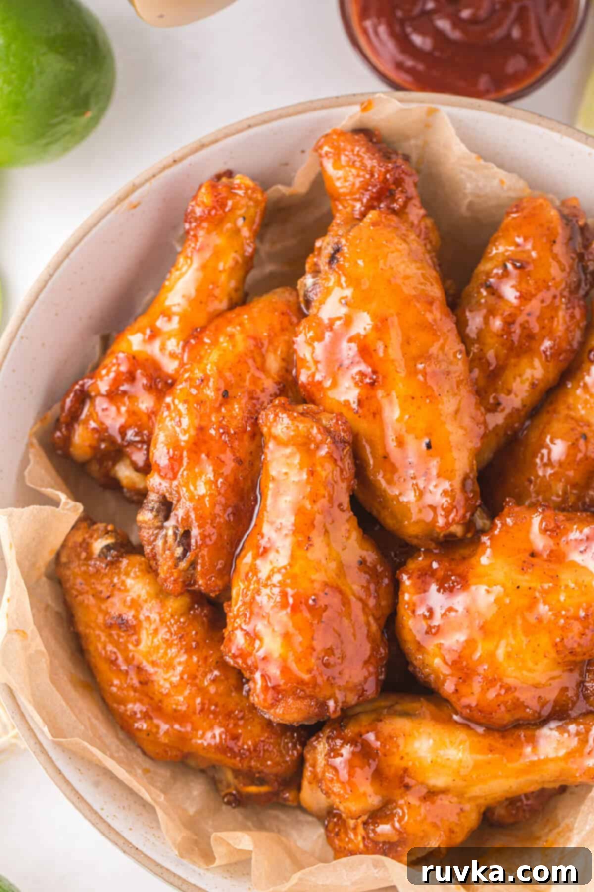 Air Fryer Magic for Crispy Leftover Wings 2 chicken wings in a bowl ready to be reheated in the air fryer.