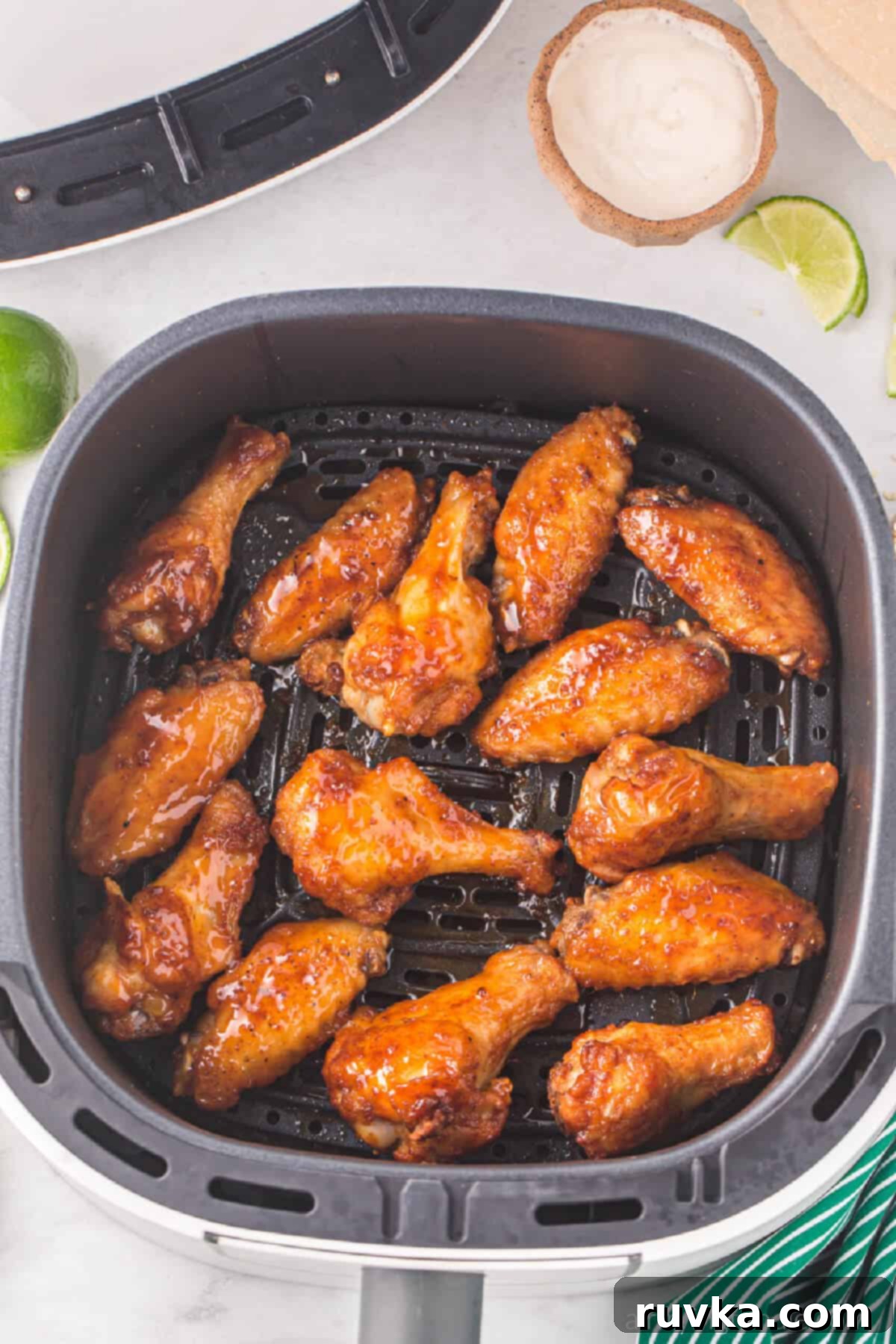 Air Fryer Magic for Crispy Leftover Wings 3 chicken wings in the basket of the air fryer.