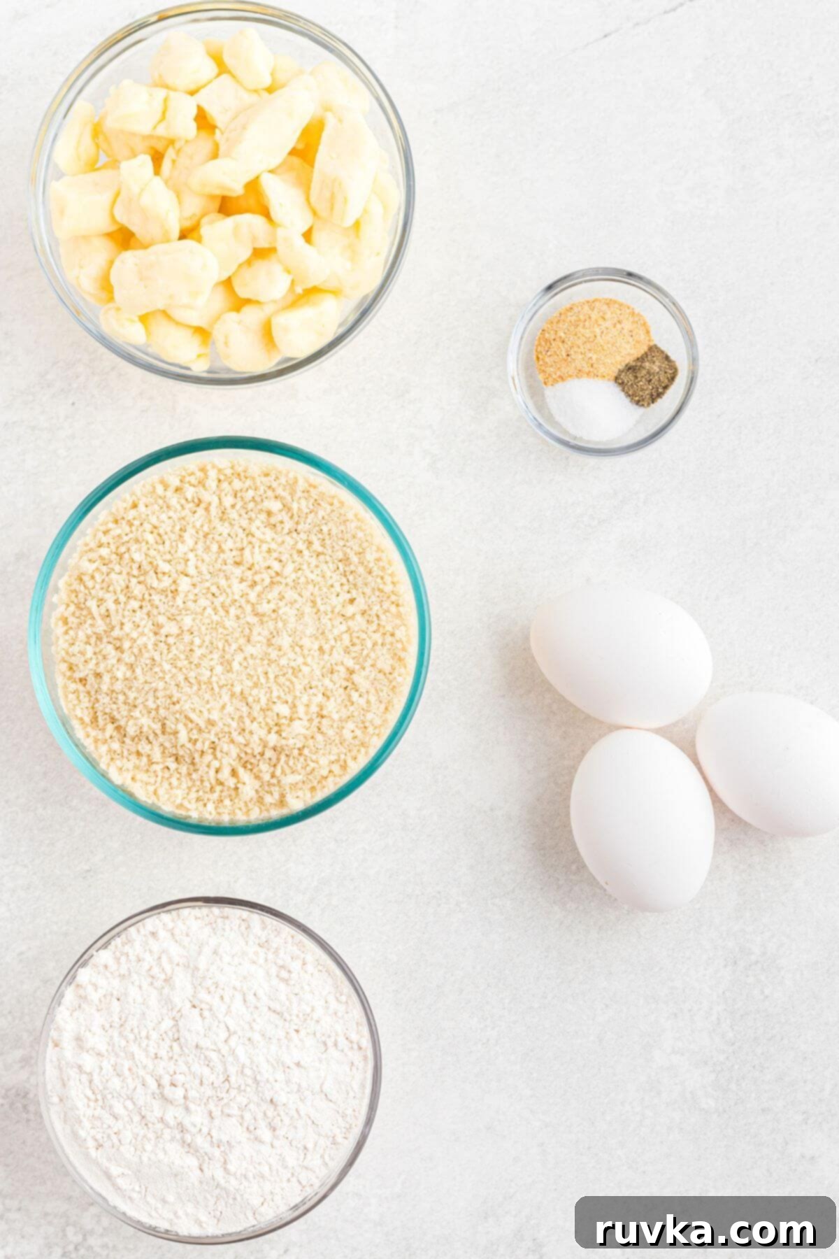 Crispy Air Fryer Cheese Curds 4 Ingredients measured on a white marble table