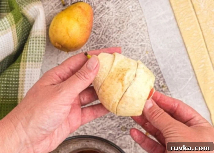 Honey Kissed Air Fried Pears 4 Strips of puff pastry wrapped around a pear, covering it before cooking in the air fryer.