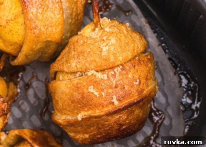 Honey Kissed Air Fried Pears 7 Golden crispy pastry wrapped pear, cooked in the air fryer basket, showing its perfect texture.