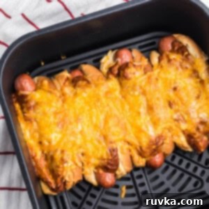 Crispy Air Fryer Chili Cheese Dogs 9 Air Fried Chili cheese dogs in the air fryer basket, ready to serve.