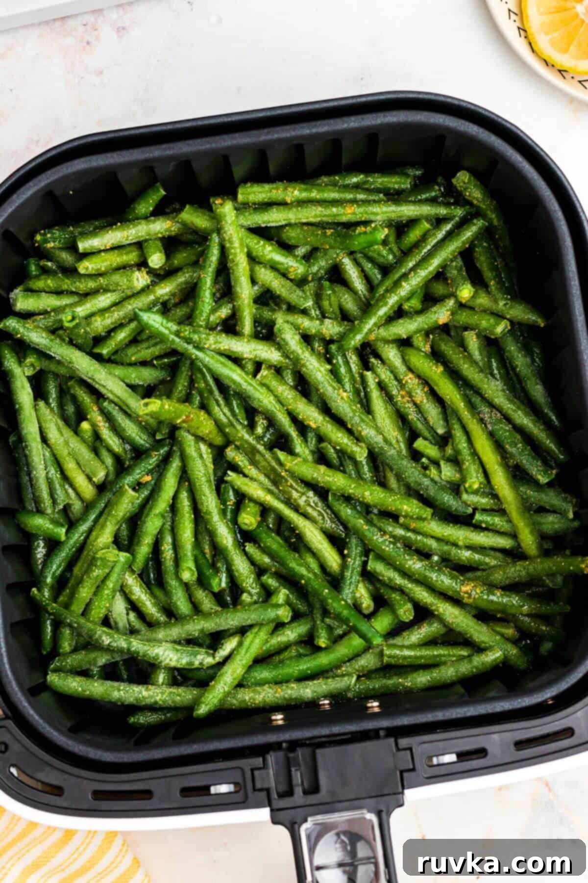Crispy Air Fryer Frozen Green Beans 6 Seasoned frozen green beans in the air fryer basket.