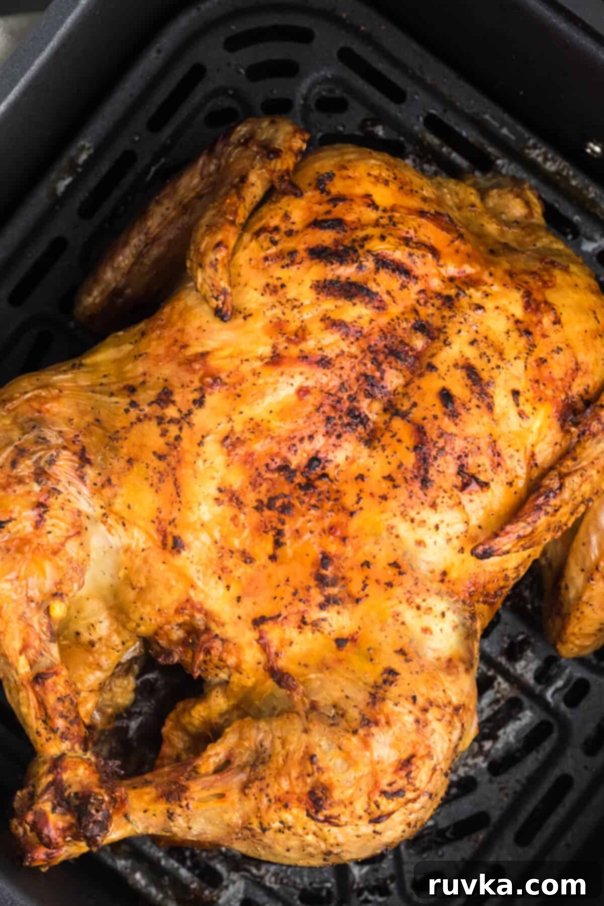 Air Fryer Magic: Reheating Rotisserie Chicken to Perfection 3 Reheating Rotisserie Chicken in air fryer basket, with chicken pieces neatly arranged for optimal air circulation.