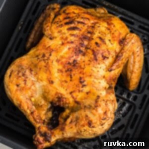 Air Fryer Magic: Reheating Rotisserie Chicken to Perfection 5 Rotisserie Chicken reheated in the air fryer, sitting in an air fryer basket, perfectly crispy and ready to be removed and served.