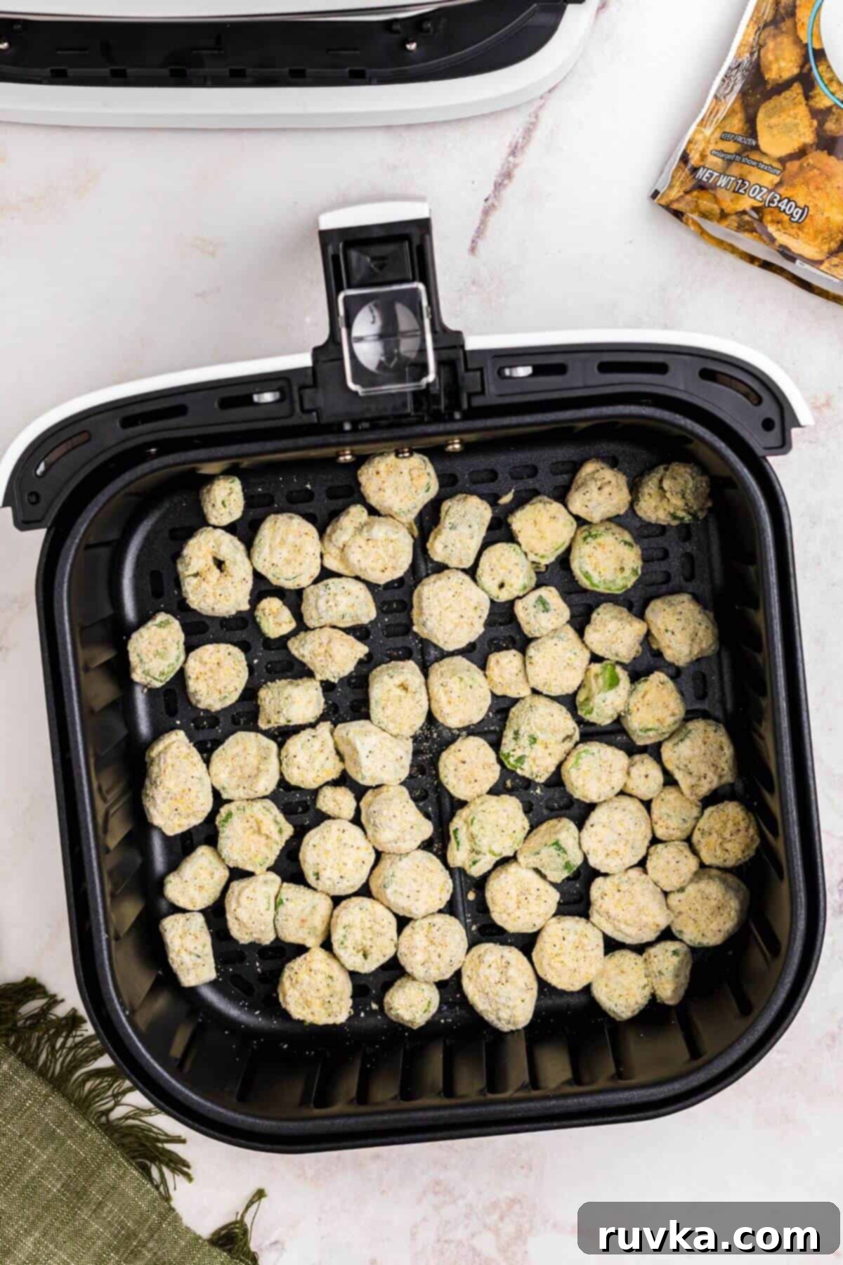 Air Fryer Magic for Frozen Okra 4 Frozen breaded okra in the air fryer basket before being air fried.