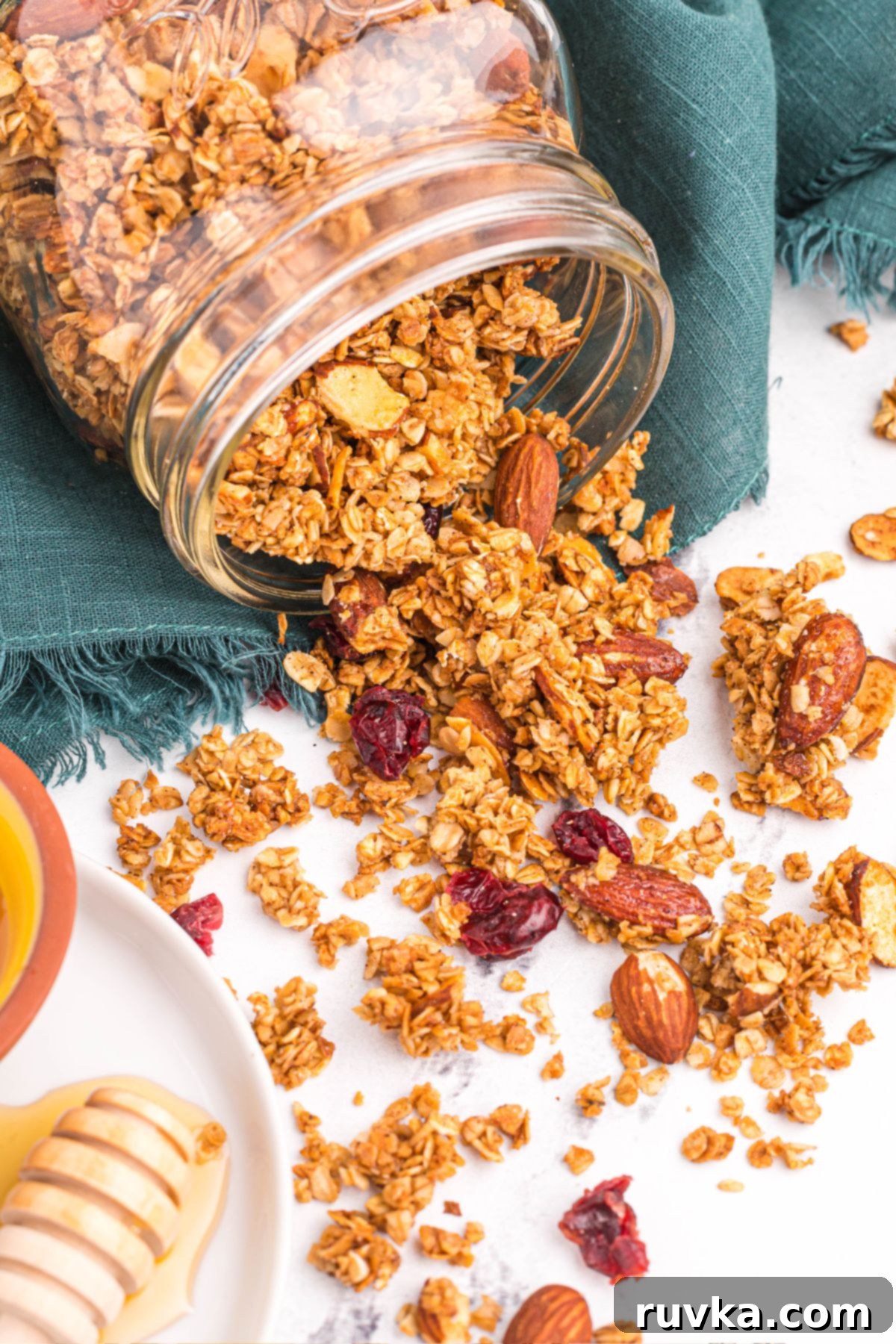 15 Cozy Autumn Air Fryer Desserts You'll Adore 8 air fryer granola in a jar being poured out onto a table.