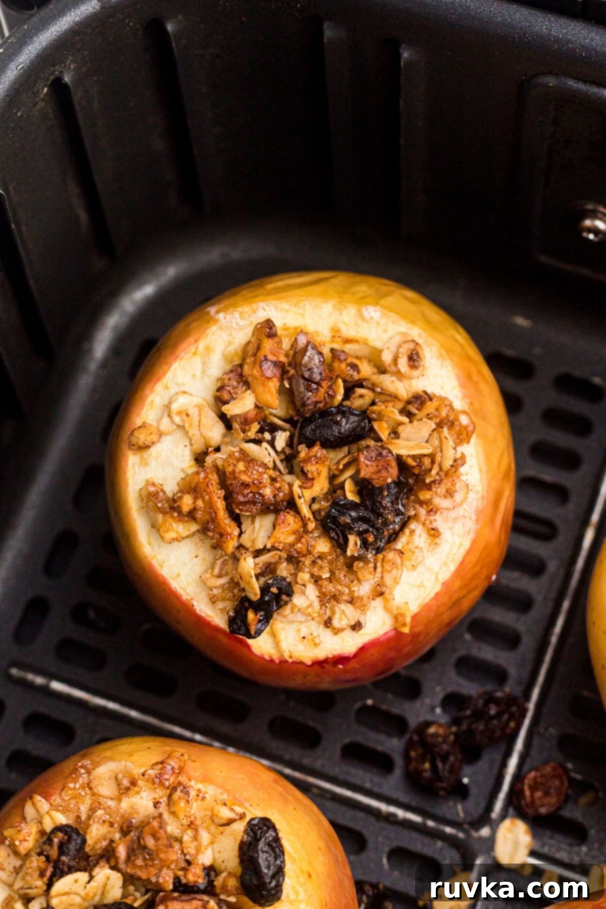 15 Cozy Autumn Air Fryer Desserts You'll Adore 10 Baked apples stuffed with oats, cranberries, sugar, and butter, and in the basket of an air fryer.