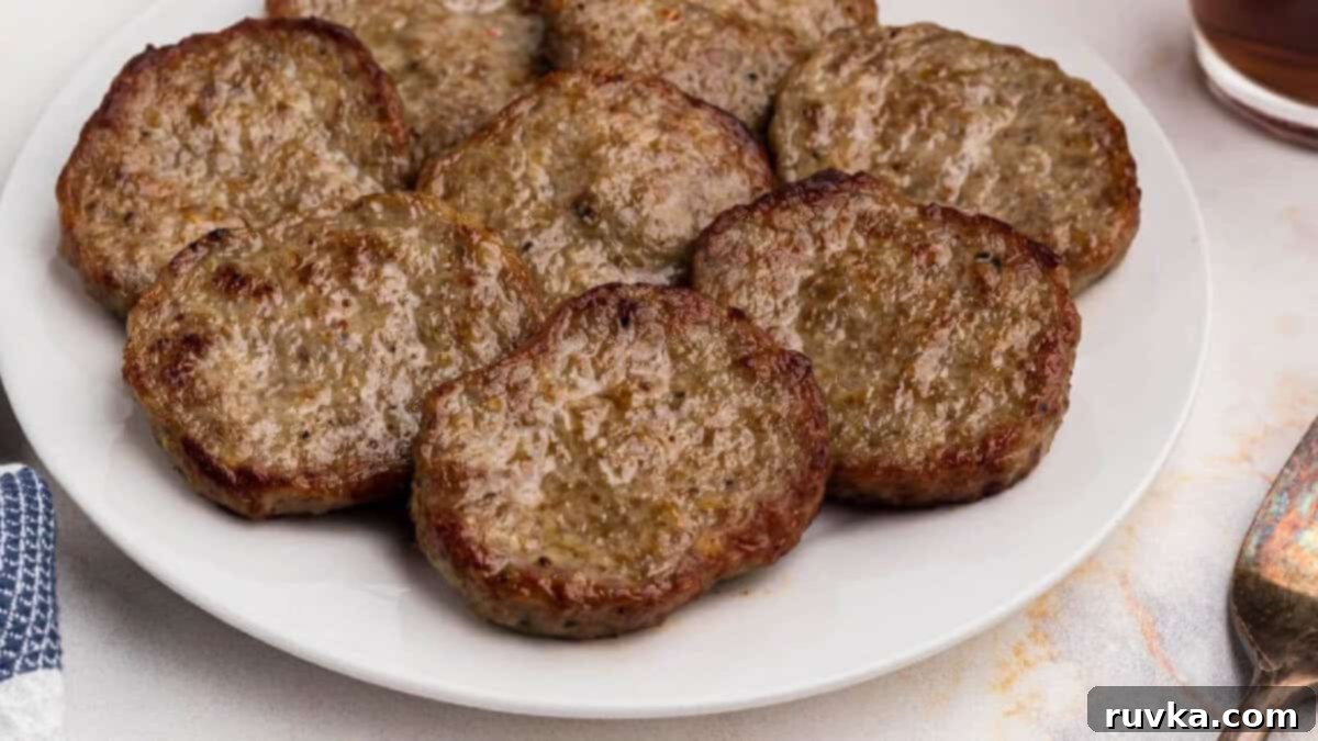 15 Effortless Breakfasts for a Perfect Start 8 Perfectly cooked air fryer sausage patties, golden and juicy, served neatly on a white plate, ready to be enjoyed as a quick and savory breakfast.
