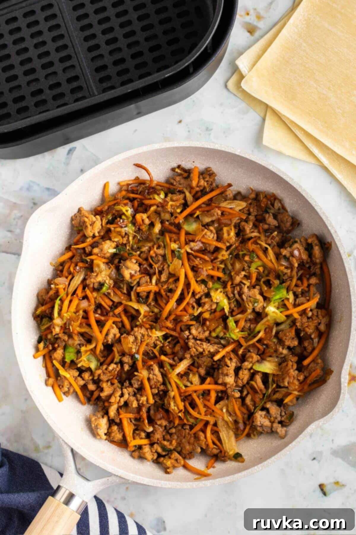 Crispy Air-Fried Egg Rolls 5 Ground pork with veggies and seasonings fried together in a pan.