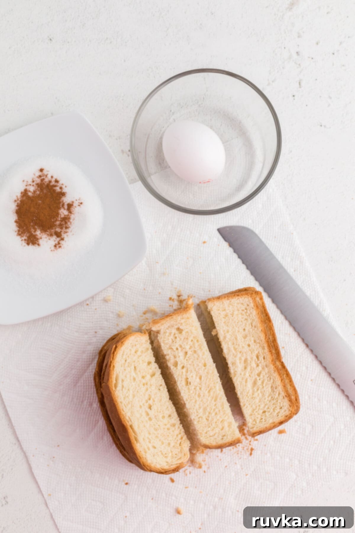 Golden Air Fryer French Toast Sticks 4 Bread sliced into thirds and cinnamon and sugar in a small bowl.