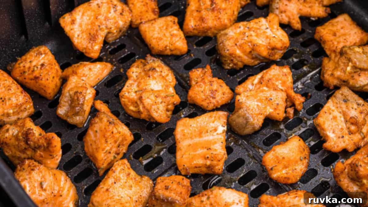 15 Foolproof Air Fryer Recipes 12 air fryer blackened salmon bites in the basket of the air fryer.