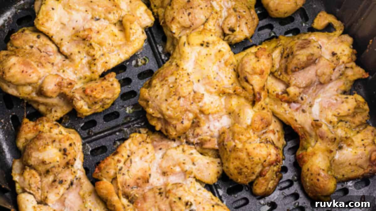15 Foolproof Air Fryer Recipes 15 lemon pepper chicken thighs in the basket of the air fryer, ready to serve.
